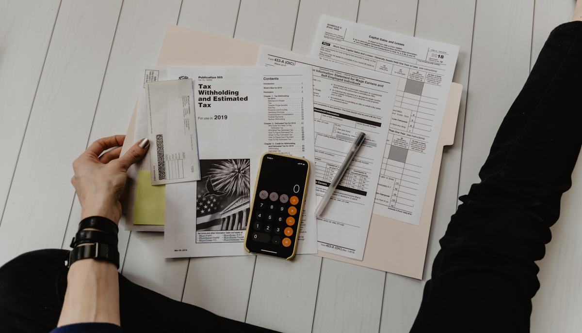 Insurance paperwork, a calculator and a pen on a desk