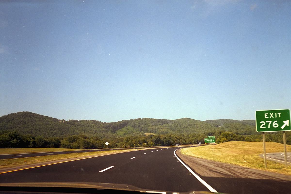 An open interstate highway with an exit sign